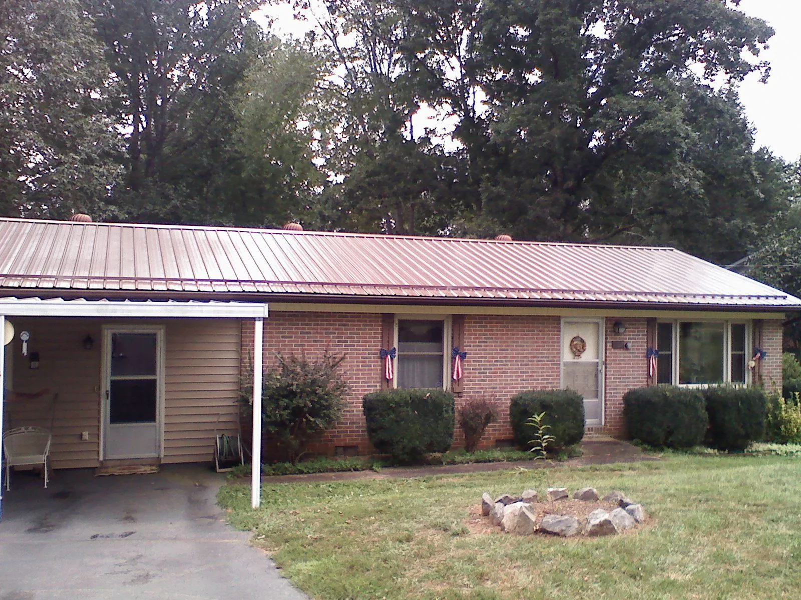Bronze metal roof and carport on a brick ranch home — Roof Repair work by our crew in Fullerton
