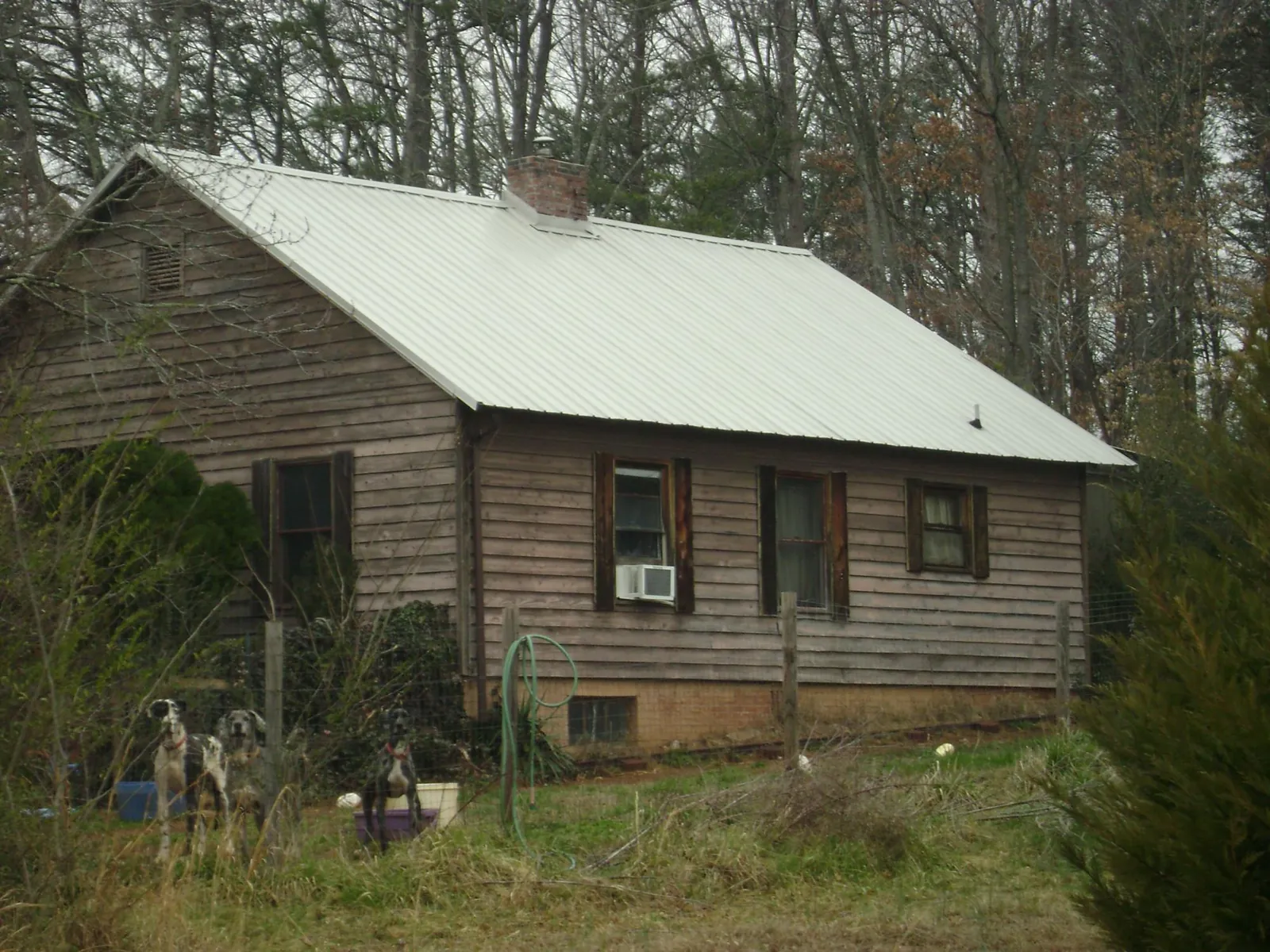 White metal roof on an old wood sided farmhouse, from a Metal Roof Installation job in Fullerton
